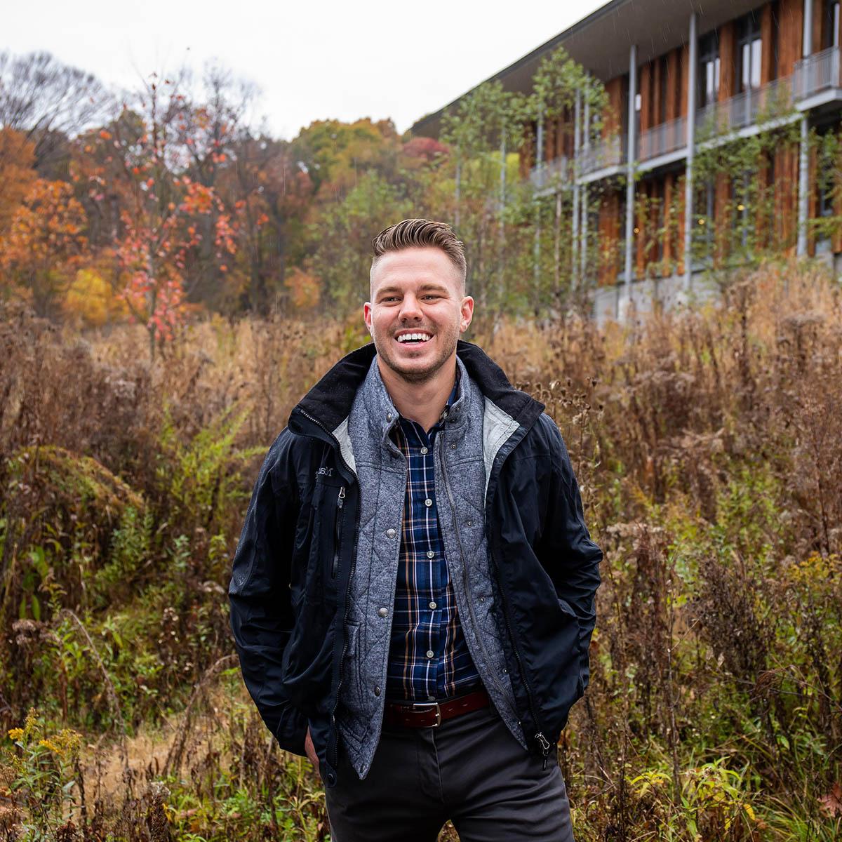 Photo of James Snow outside with autumn foliage